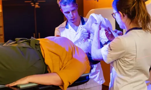 two researchers and a patient during treatment